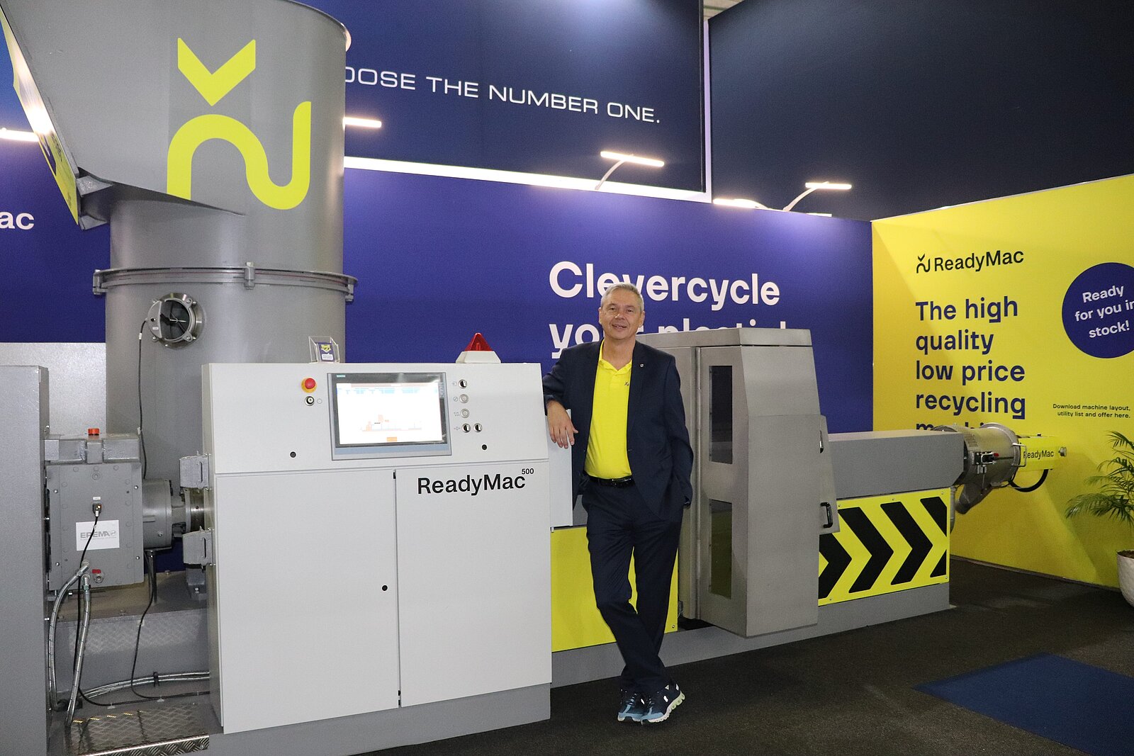The picture shows Mr Michael Köhnhofer standing in front of a recycling machine 